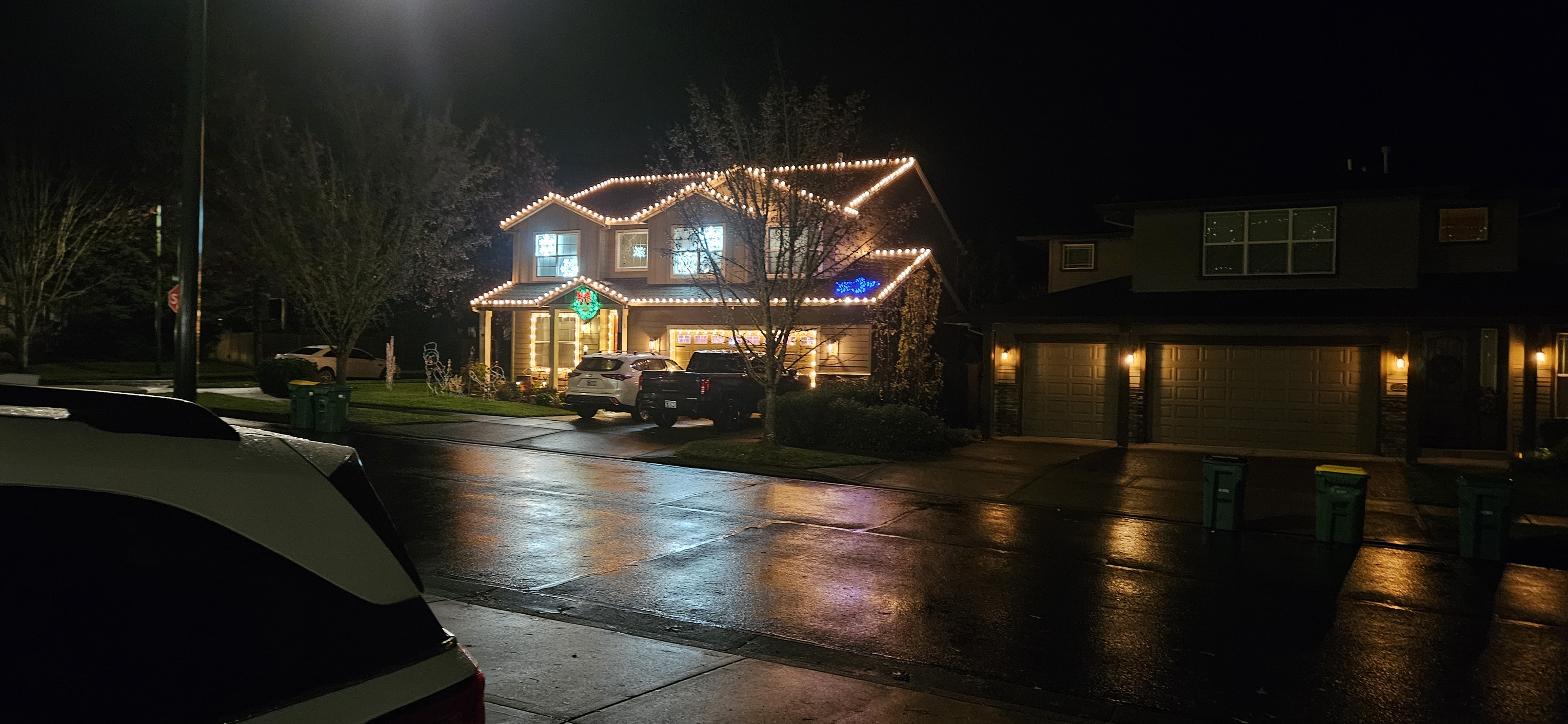 Warm white Christmas lighting on a home from the street