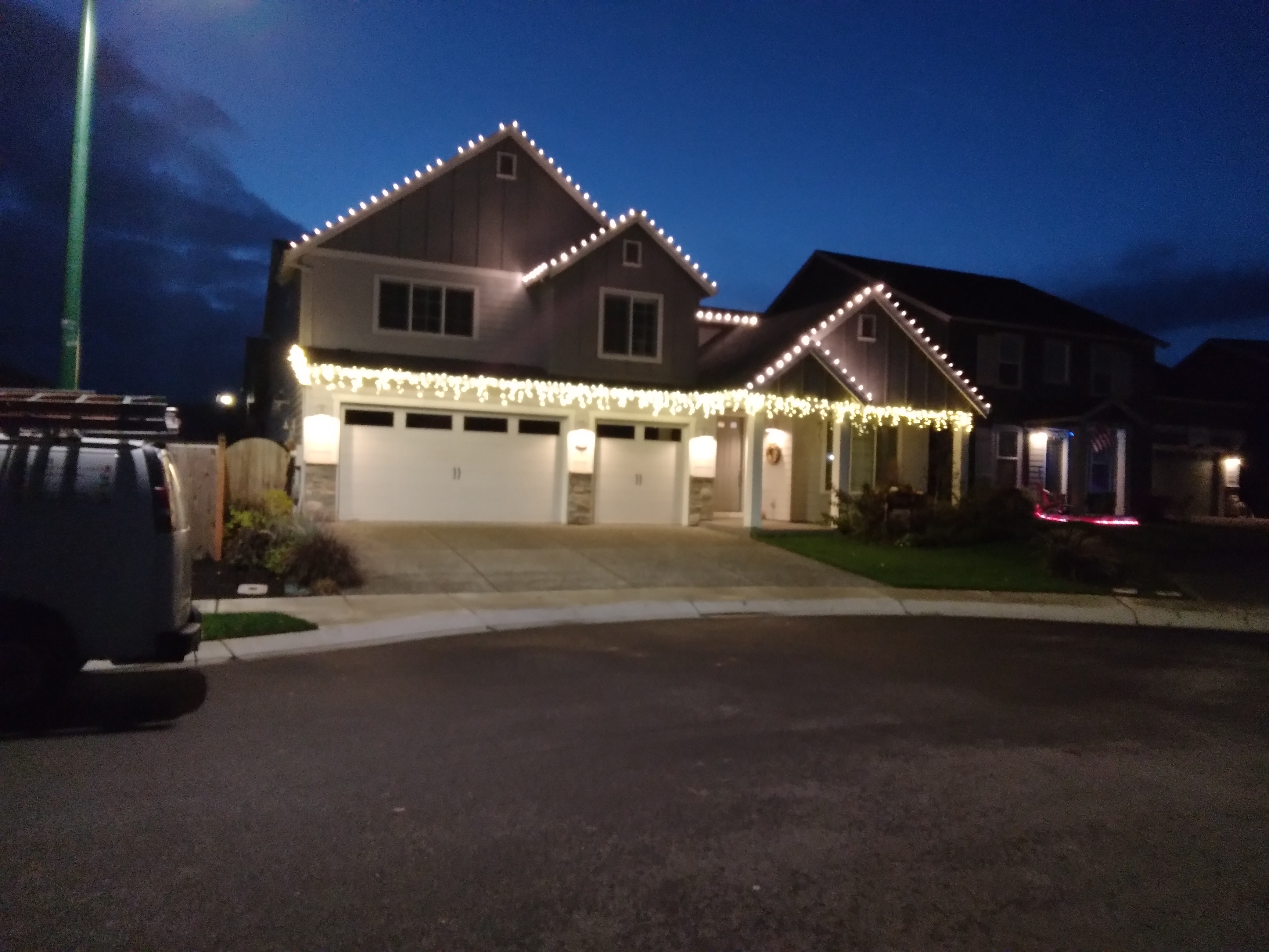 Warm white C9 Christmas lights on a two-story home