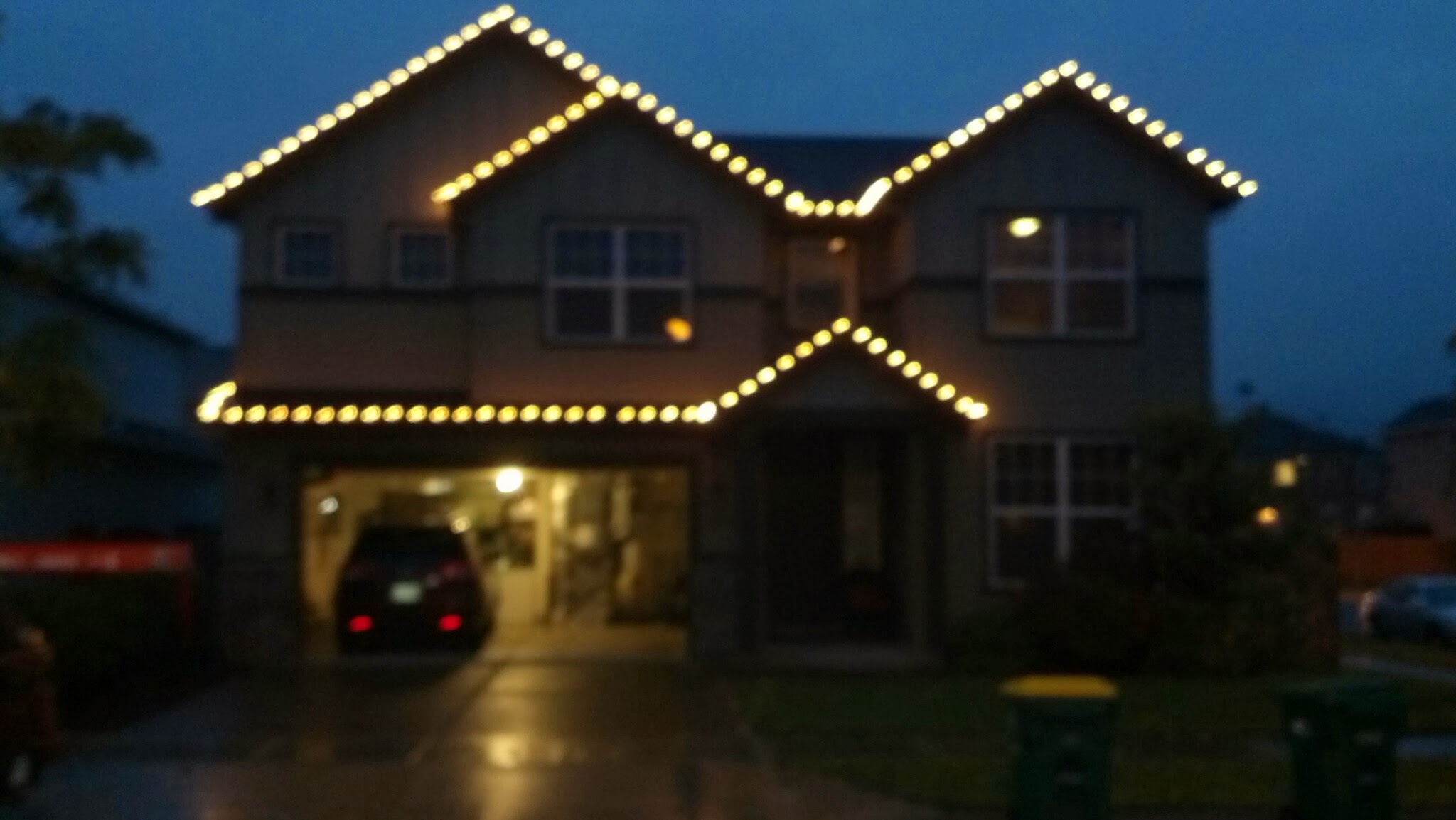 Warm white Christmas lights along a peaked roofline